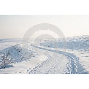 Is faintly visible in the misty distance, adding depth to the