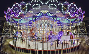 Fair.Carousel with horses. Horse rides kids carousel at the fair