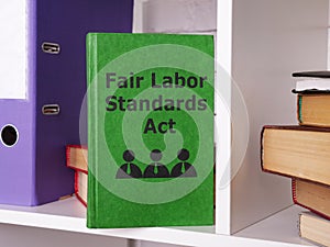 Fair Labor Standards Act FLSA is shown using a text on the book