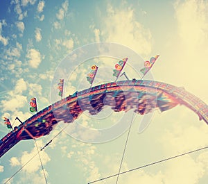 Fair ride at dusk toned with a retro vintage instagram filter app or action