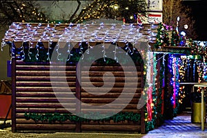 Fair stalls in the New Year or Christmas town. Night background with selective focus and copy space