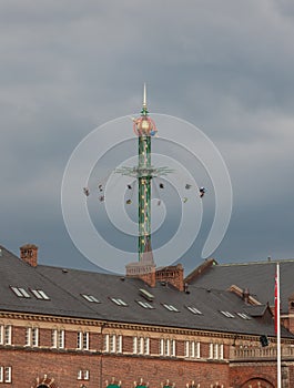 The fairground fun fair in tivoli gardens. Copenhagen, Denmark, on a gray sky