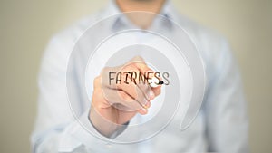 Fairness , Man writing on transparent screen photo