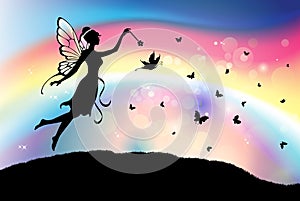 Fairy butterfly silhouette with magic wand rainbow sky background