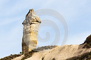 fairy chimney rock on mountain slope in Goreme