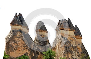 Fairy chimneys isolated in white background. They are towering rock formations in Cappadocia Turkey