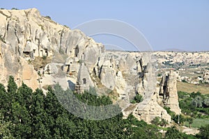 Fairy chimneys panorama against a mid blue sky- Cappadocia