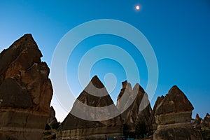 Fairy Chimneys. Peri bacalari or fairy chimneys at sunrise with moon on the sky