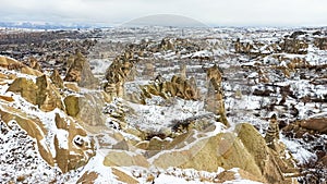 Fairy Chimneys with snowy landscape in Cappadocia