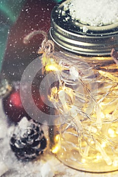 Fairy christmas holiday lights in a jar with christmas decoration, christmas or xmas concept