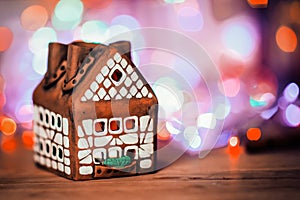 Fairy Christmas house cake with candle light inside, narrow depth of field and background lights