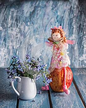 Fairy composition with a fairy in a pink dress, an apple and a bouquet