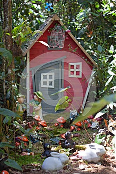 Fairy house in the woods with various gnomes, elves and other figurines