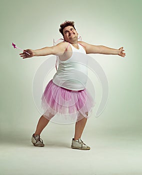 Fairy, man and studio for magic and isolated, happy male person with wings and pretend costume. Pink Cosplay, fun and