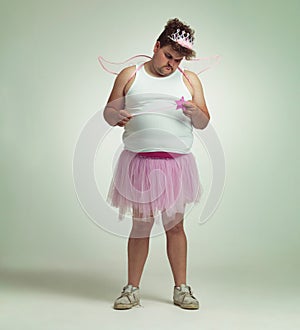 Fairy, man and studio portrait for magic and isolated, sad male person with wings and pretend costume. Pink Cosplay