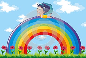 Fairy relaxing on colorful rainbow