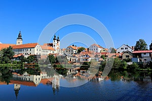 A fairy tale castle and old town city with lakeside mirror reflection in Telc, Czech Republic