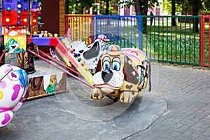 Fairy-tale figures on children\'s carousel in the city park in the morning. Nobody here. Carousels are waiting for children.