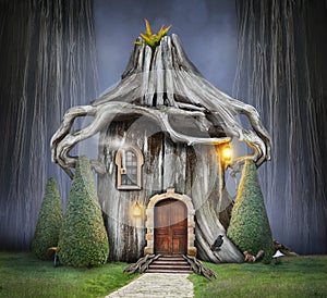 Fairy tree house with roof of roots in fantasy forest