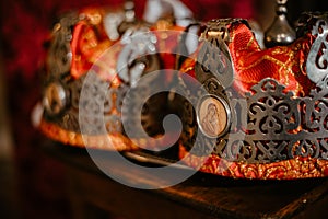 Fairytale couple, bride and groom in crowns during wedding ceremony in church