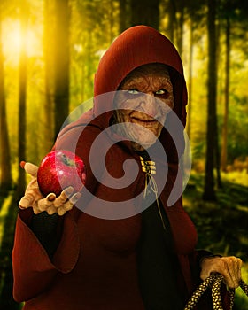 Fairytale evil old witch holding a poisoned red apple at twilight photo