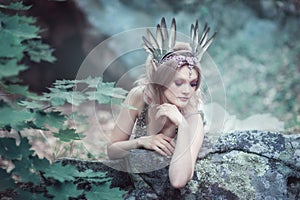 Fairytale girl in beautiful stones. Stones in the moss.