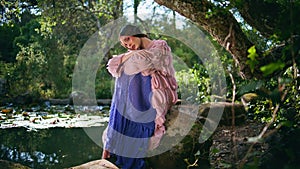 Fairytale girl posing beautiful nature lake landscape. Charming woman nymph