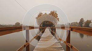 Fairytale house in the middle of the lake on an autumn foggy morning aerial