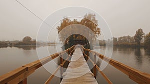 Fairytale house in the middle of the lake on an autumn foggy morning aerial