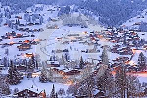 The fairytale-like Grindelwald villages at twilight in Swiss Alps photo