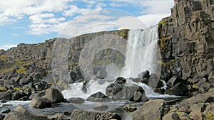 Fairytale timelapse of picturesque waterfall, clouds is moving to a distance, soft sun is shining