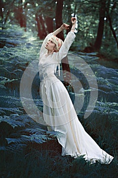 Fairytale woman dancing in forest