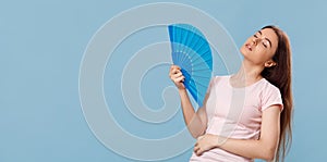 Fait hair beautiful lady blowing with hand fan