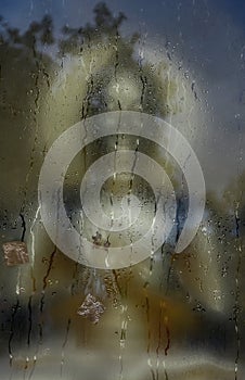 Faith abstract with buddha statue and rain drop on the window.