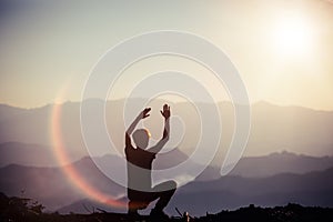 Spiritual prayer hands over sun shine with blurred beautiful sunset background