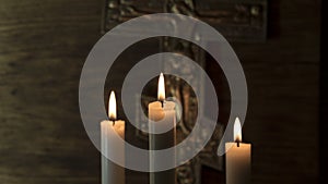 Faith in God. Crucifixion against the background of three candles