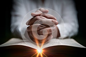 Faith with holy bible concept. Hands of a female prayer worship God with holy bible on black background in church. Christian woman