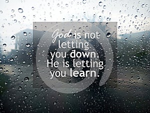 Faith inspirational words - God is not letting you down. He is letting you learn. On background of raindrop on glass window.