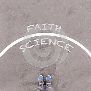 Faith vs science text on asphalt ground, feet and shoes on floor