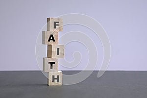 Faith word written on stacked up wood cubes