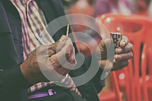 Faithful Asian Elder Praying in the Holy Communion and Praise Jesus