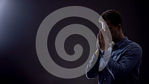 Faithful male praying to God, asking for blessing and forgiveness, belief