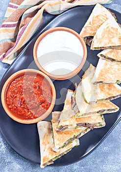 Fajita quesadilla with pieces of beef steak, green bell pepper, onion, cheese, vertical top view