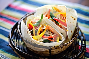 fajita wraps with sour cream and cheddar in a basket