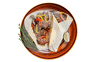 Fajitas Tortilla wraps with beef meat steak stripes, sweet pepper and onions. Isolated on white background.