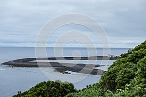 Fajã da Caldeira de Santo Cristo, a small inhabited headland on the island of Sao Jorge, Azores