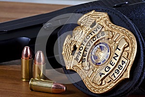 Fake badge made by photographer with handgun, and bullets on wood.