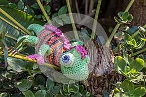 A fake chameleon in a shrub