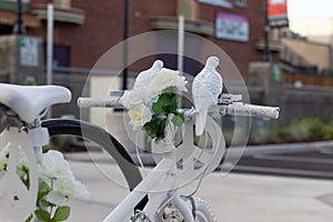 Fake doves on a white peace bike perspective from bike handles