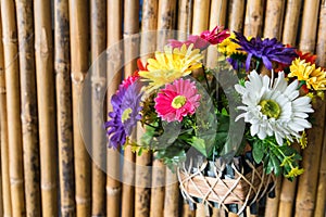 fake fabric flowers on bamboo wall